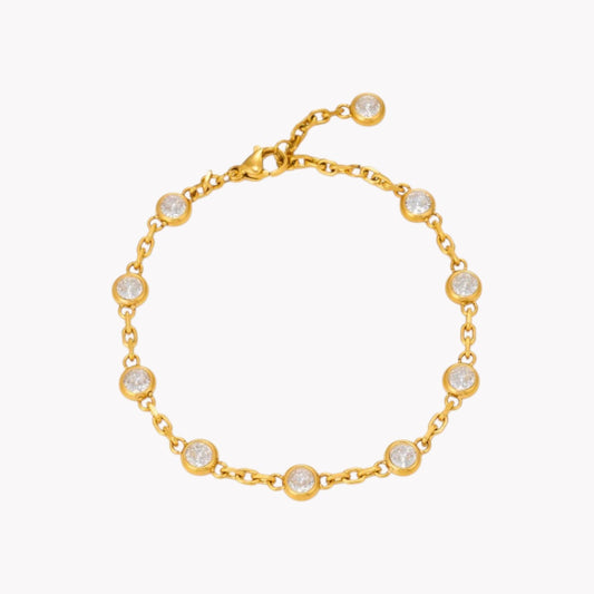 A gold chain bracelet with eight bezel-set clear round stones, displayed on a clean white background.
