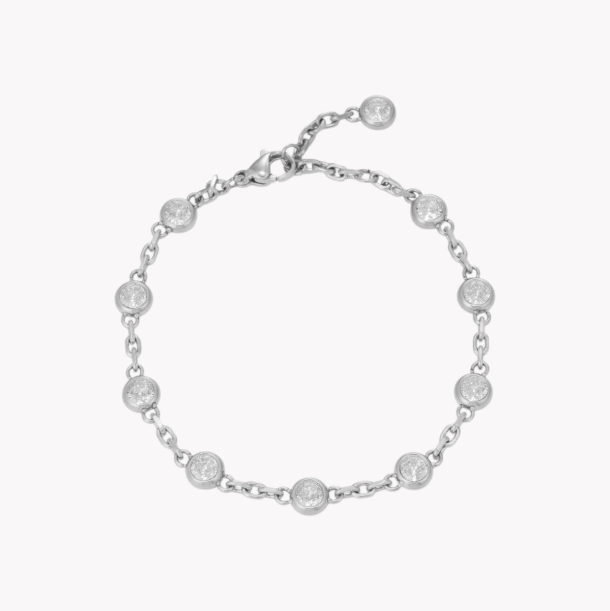 A silver chain bracelet with multiple small round bezel-set clear stones, displayed on a light gray background.
