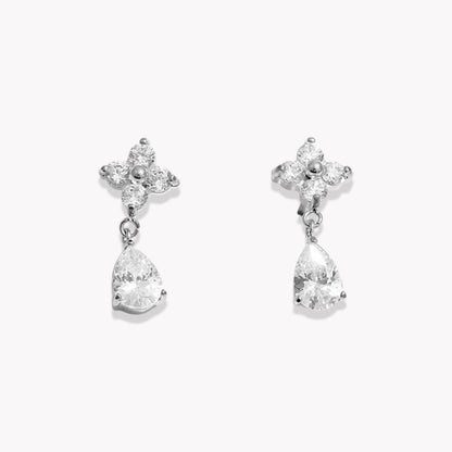 Pair of silver earrings with teardrop-shaped crystals on a white background