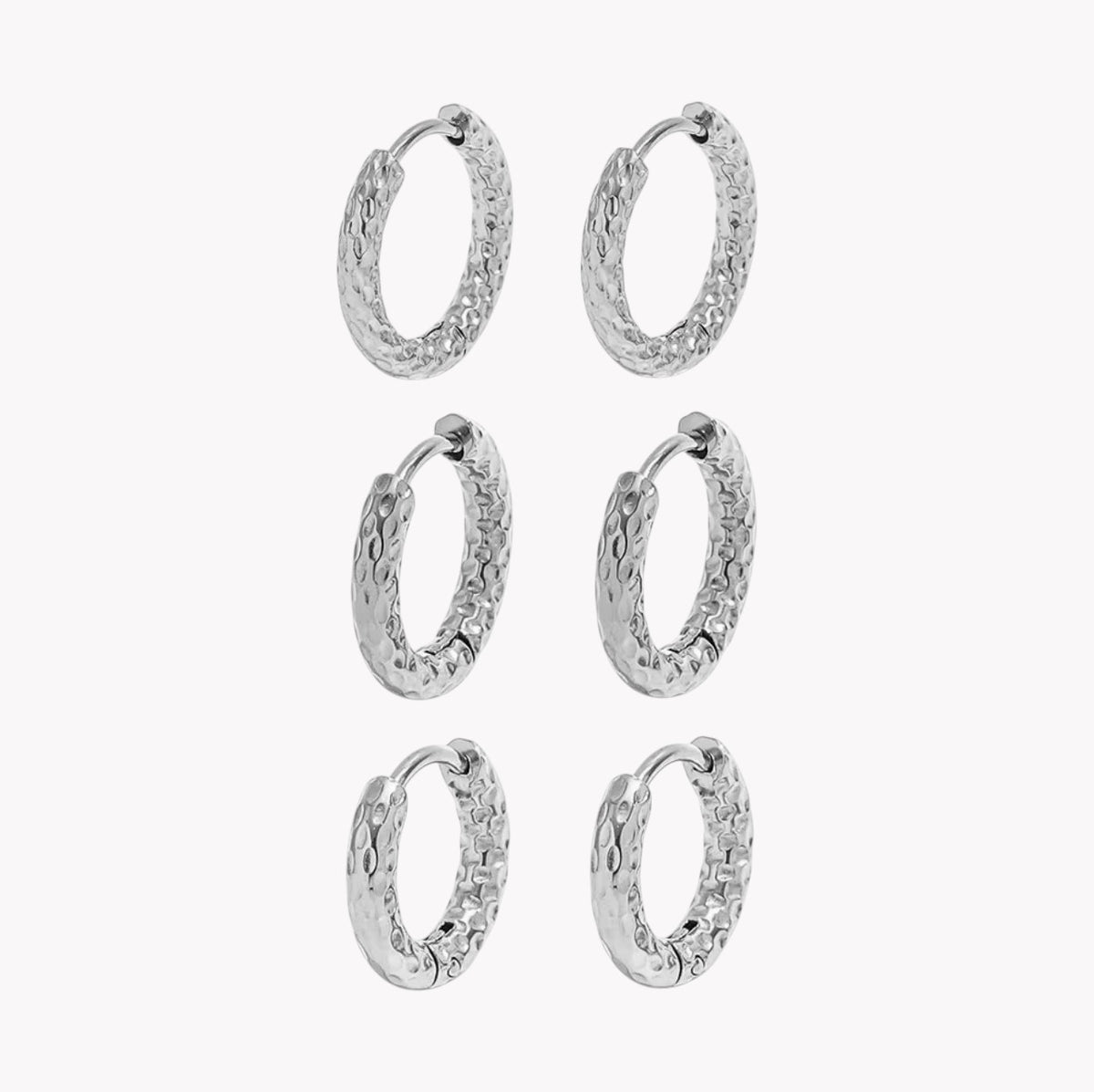 Six silver textured hoop earrings arranged in a 3-by-2 grid on a plain light gray background.