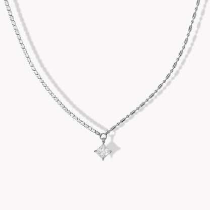Silver necklace with a square shaped pendant on a white background