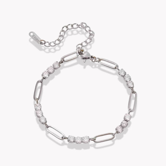 Silver bracelet with clear stones on a white background