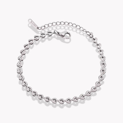 A silver bracelet with heart shaped link details, featuring a link chain design and a branded clasp.