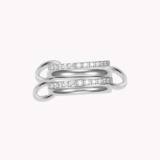 Silver layered link ring, featuring 4 bands - two plan silver and 2 with clear gemstones. Held together by three smaller links pictured on a white background