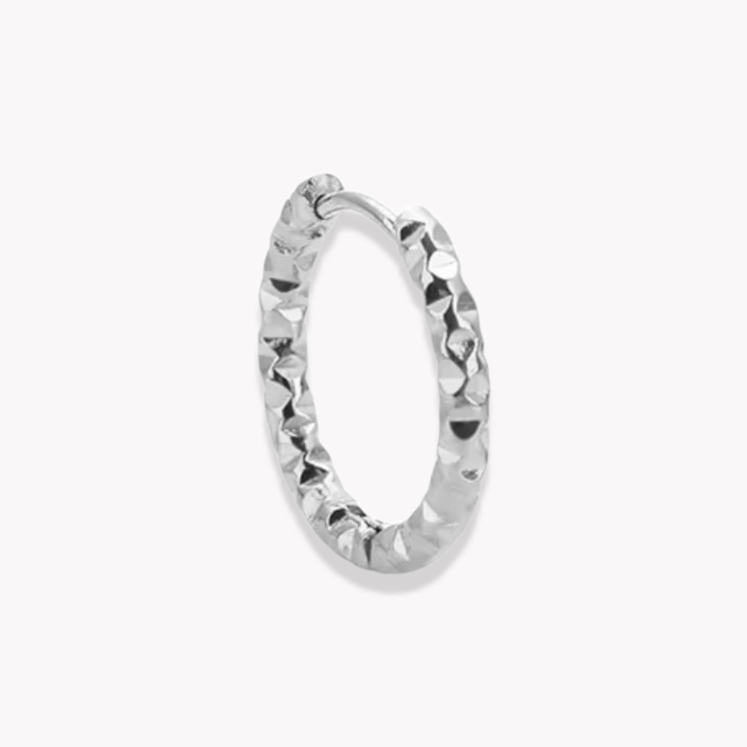 Silver hooped earring with a textured finish photorgraphed on a white background