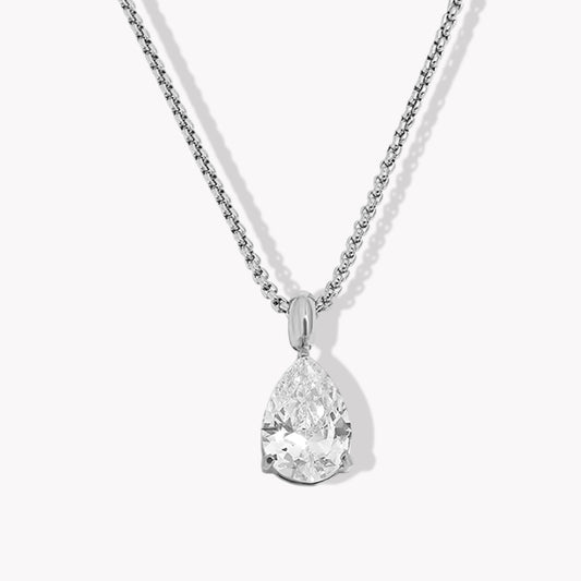 Silver necklace with a teardrop-shaped diamond pendant on a white background