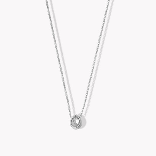 A silver necklace with a central pendant featuring a zircon pear shaped gemstone, attached to a fine chain.