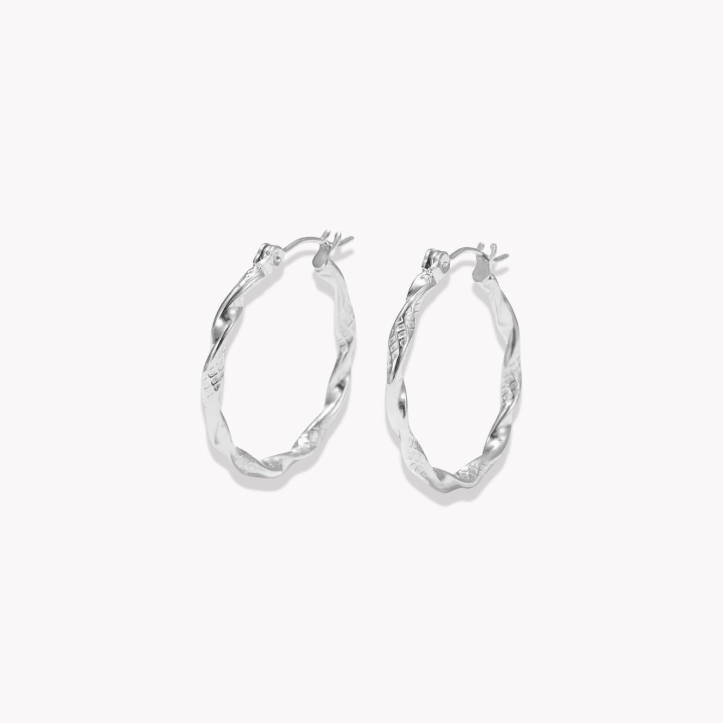 Silver twist hoop earrings on a white background