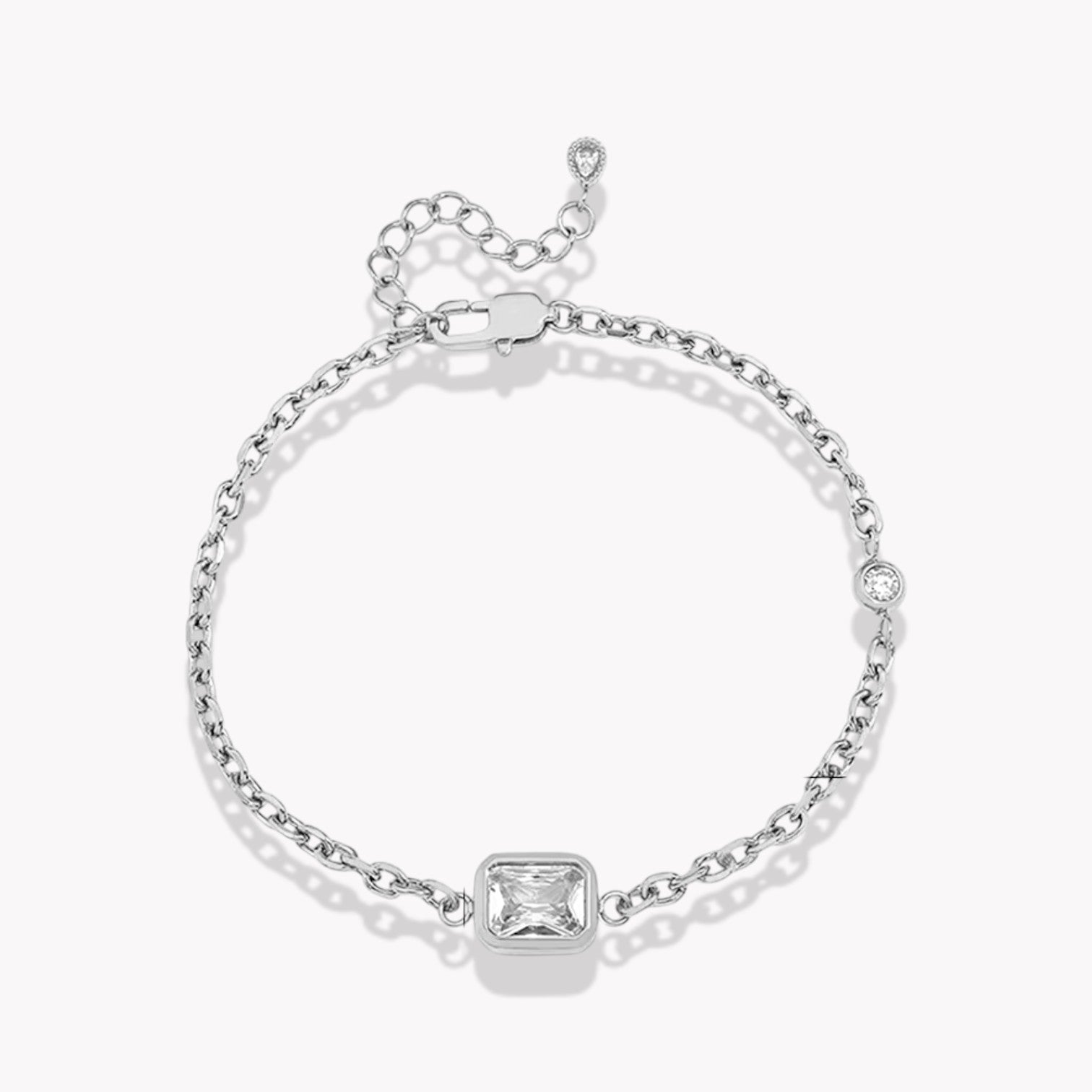Silver bracelet with a square-cut gemstone on a white background