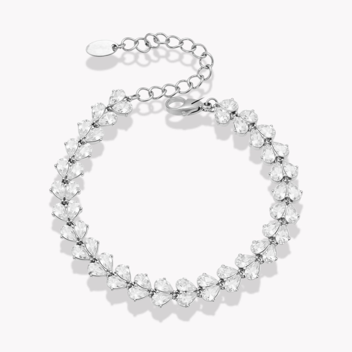 Silver bracelet with clear pear shaped gemstones on a white background