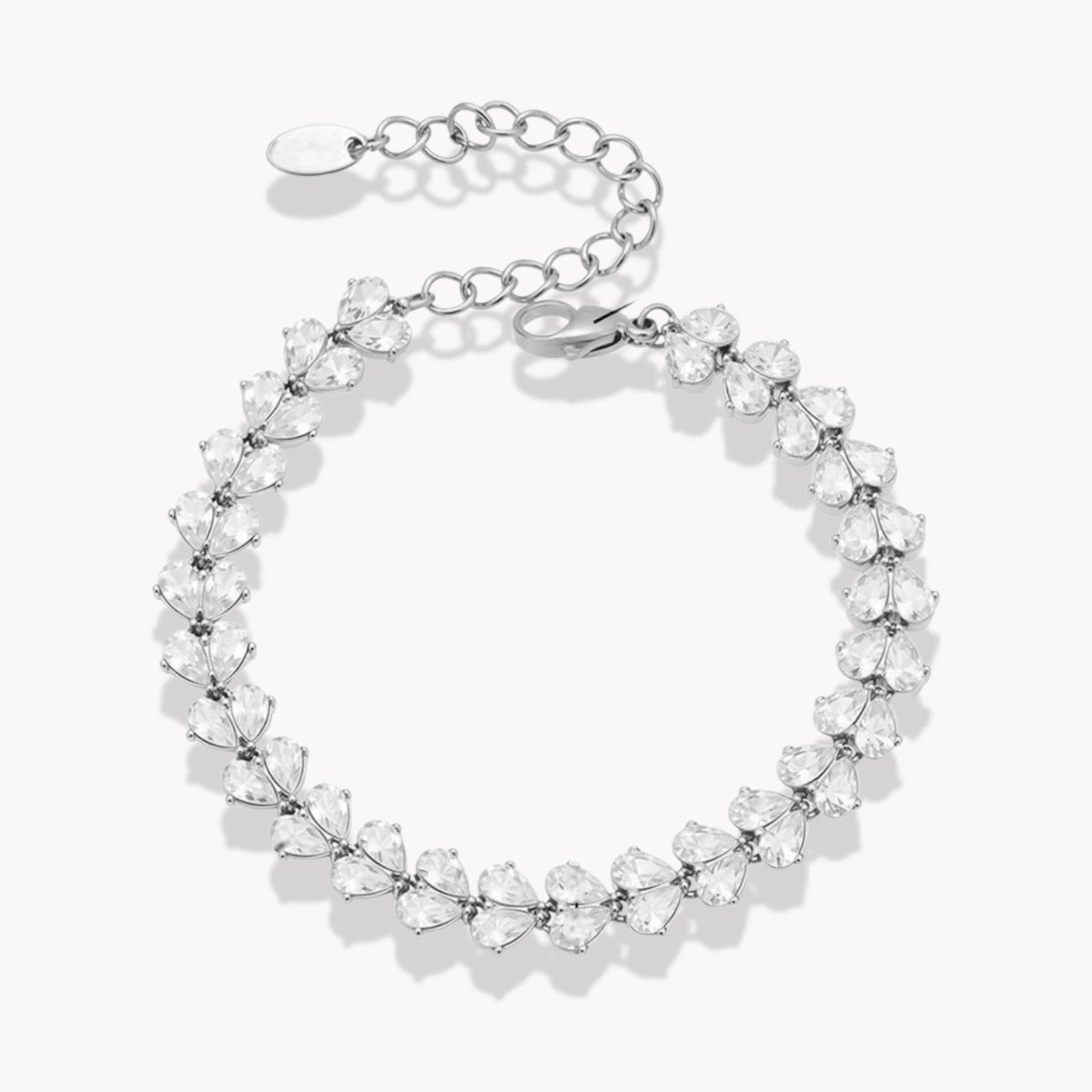 Silver bracelet with clear pear shaped gemstones on a white background