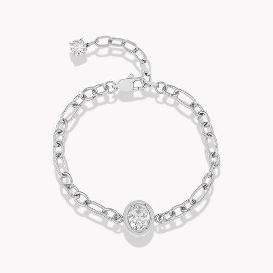Silver chain bracelet with large central oval diamond. Bracelet has an extender with a clear gemstone on the end. Pictured on a white background