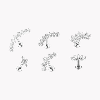 Set of silver earrings with clear gemstones on a white background