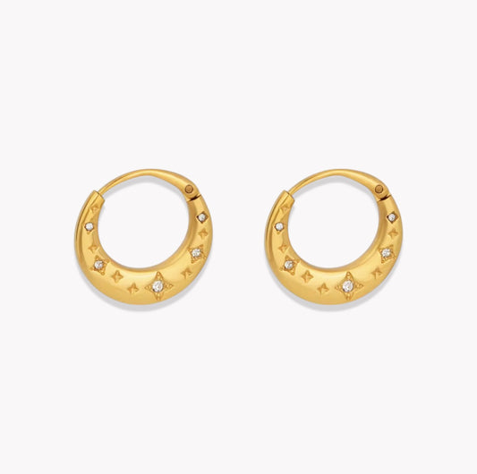 Gold hoop earrings with star designs on a white background