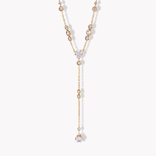 Gold necklace with gemstones on a white background