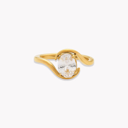 Gold ring with a clear gemstone on a white background
