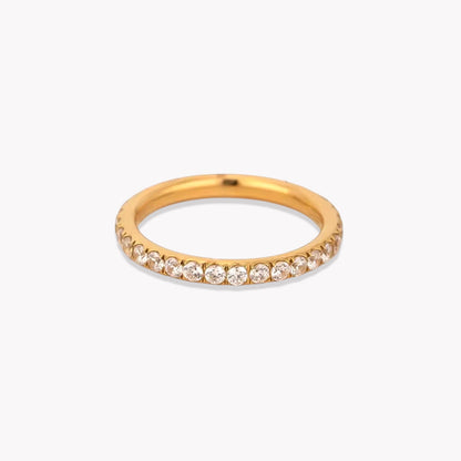 Gold ring with small diamonds on a white background