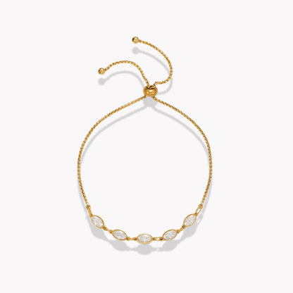 Gold bracelet with five clear oval stones on a white background