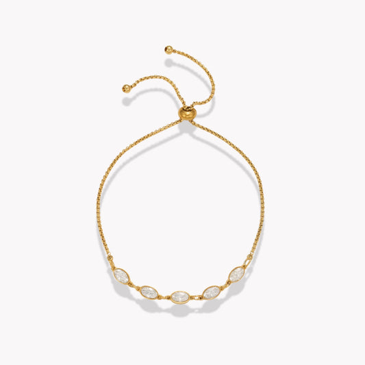 Gold bracelet with five clear oval stones on a white background