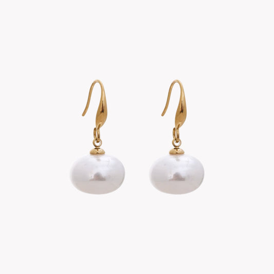Pair of pearl earrings with gold hooks on a white background