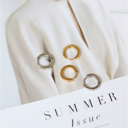 Three gold rings on a white surface with 'Summer Issue' text