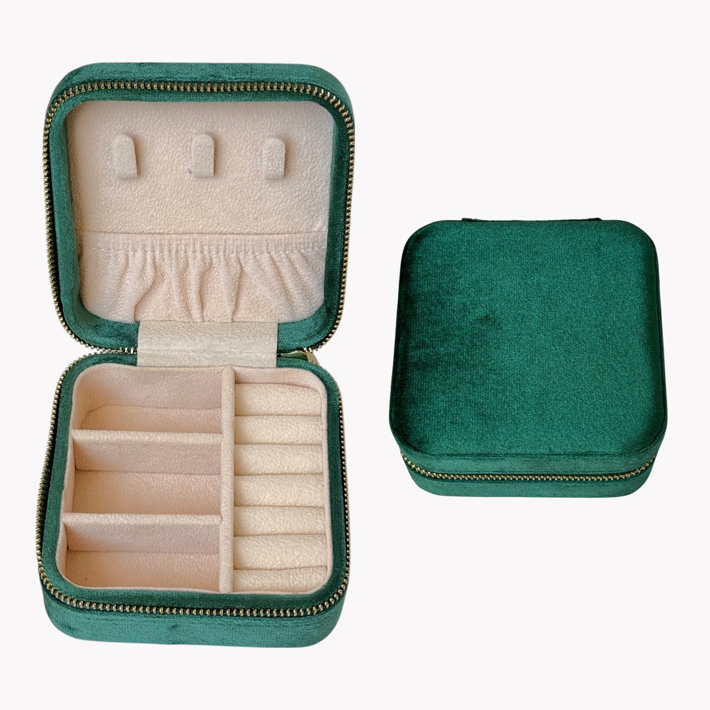 Green jewelry case with open lid showing compartments for earrings and rings on a white background