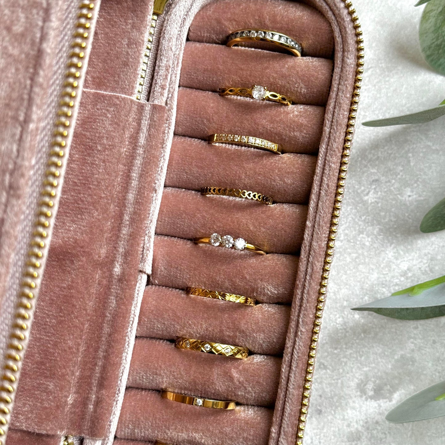 Dusky Pink jewelry case with gold rings on a light grey background