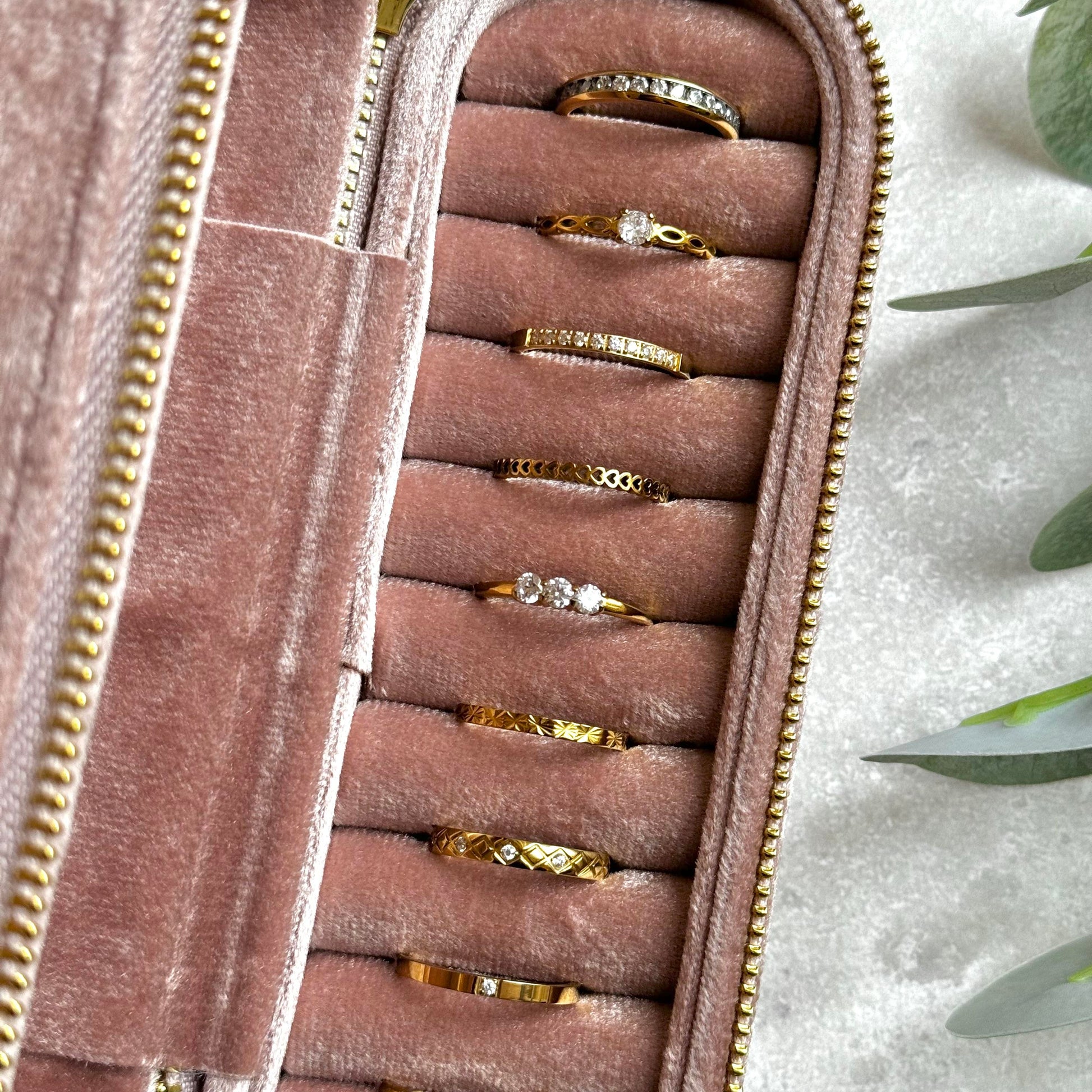 Dusky Pink jewelry case with gold rings on a light grey background