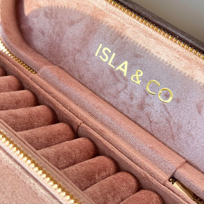 Pink jewelry case with 'ISLA & CO' branding on a light background