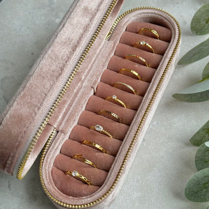 Dusky Pink jewelry case with gold rings on a light grey background