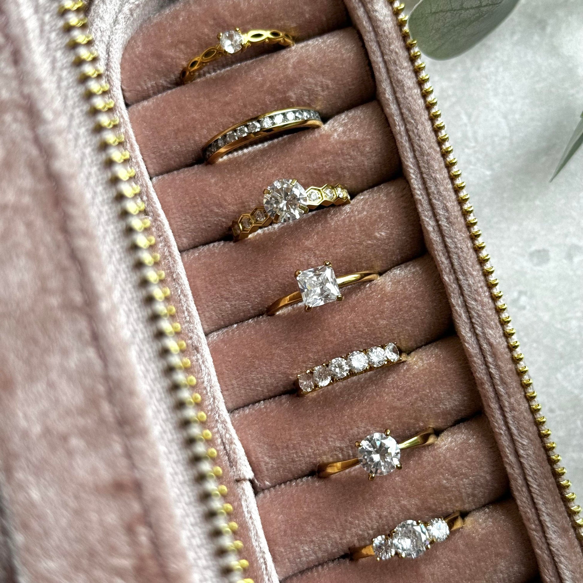 Dusky Pink jewelry case with gold rings on a light grey background