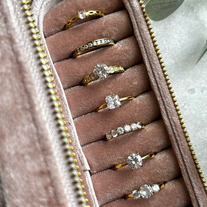 Dusky Pink jewelry case with gold rings on a light grey background