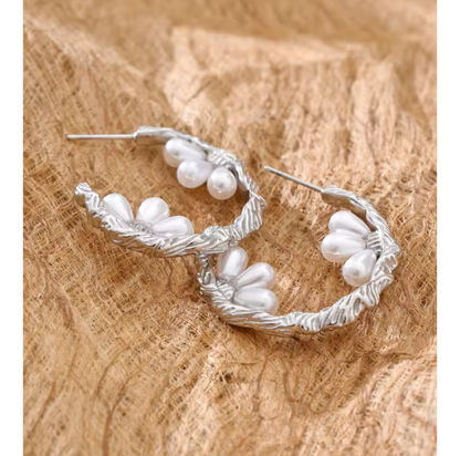 silver hooped earrings featuring pretty pearl detail photographed on a light hessian background