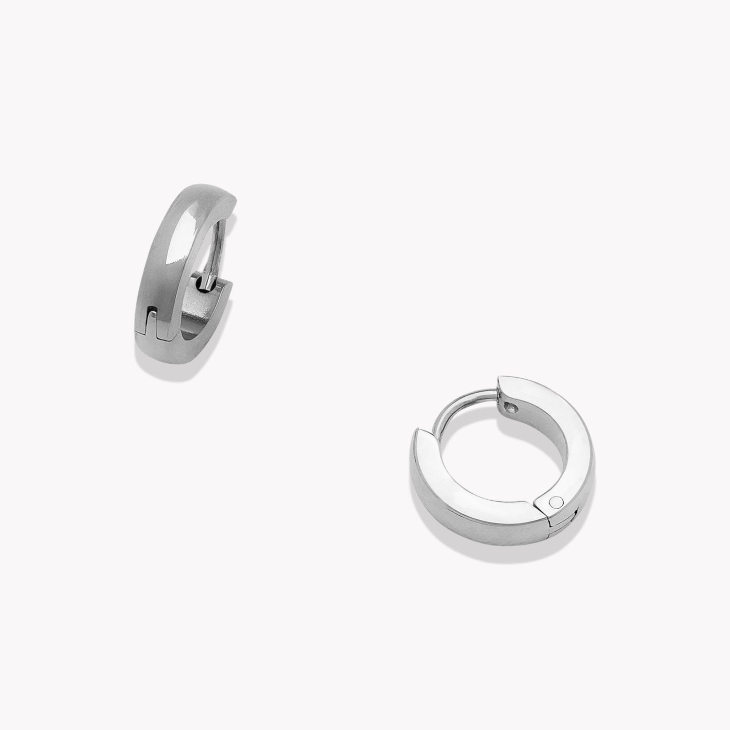 Pair of silver hoop earrings on a white background